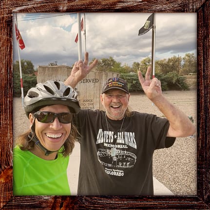 Photo, Day 34 of the TransAmerica Bicycle Trail, Mandy with Dan Morin in front a the Olney Springs Veterans Memorial