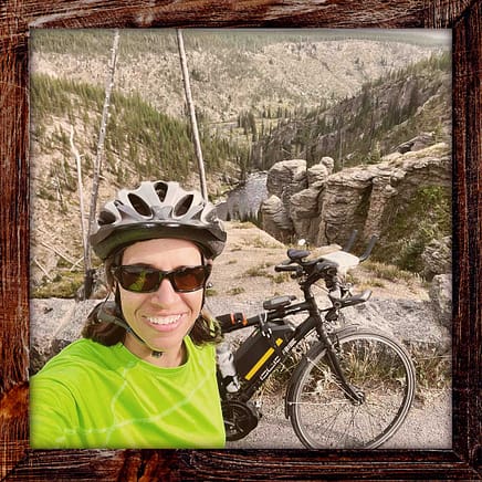 Photo, Day 21 of the TransAmerica Bicycle Trail, Mandy in front of a canyon in Yellowstone National Park