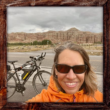 Photo, Day 23 of the TransAmerica Bicycle Trail, Mandy in front of striated rock formations