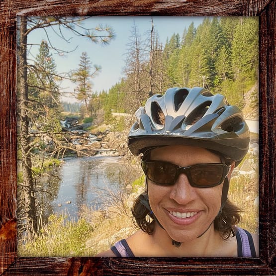 Photo, Day 12 of the TransAmerica Bicycle Trail, Mandy in front of waterfall near New Meadows Idaho